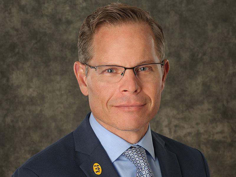 Headshot of man in suit